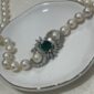 collar de perlas con broche de esmeraldas